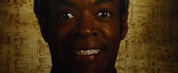 Movie still from “Oldboy” (2013), directed by Spike Lee – A man's face smiling for the camera; Extreme Close Up shot, Overhead angle