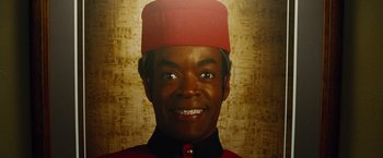 Movie still from “Oldboy” (2013), directed by Spike Lee – A person wearing a red hat; Close Up shot, Low angle