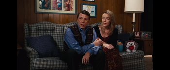 Movie still from “Oldboy” (2013), directed by Spike Lee – A man and a woman sitting on a couch together; Medium shot, Over the shoulder angle