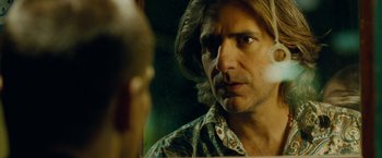 Movie still from “Oldboy” (2013), directed by Spike Lee – A person looking at a mirror; Close Up shot, Over the shoulder angle