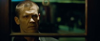 Movie still from “Oldboy” (2013), directed by Spike Lee – A person wearing a suit and tie; Close Up shot, Over the shoulder angle