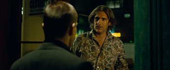 Movie still from “Oldboy” (2013), directed by Spike Lee – A man with long hair is talking to another man; Close Up shot, Over the shoulder angle