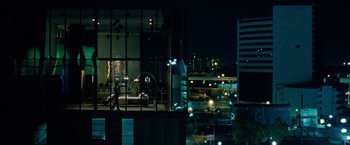 Movie still from “Oldboy” (2013), directed by Spike Lee – A view of a city at night through a window; Extreme Wide shot, Over the shoulder angle