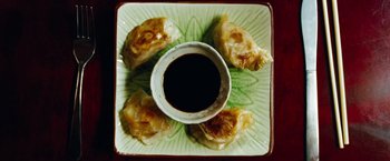 Movie still from “Oldboy” (2013), directed by Spike Lee – A plate of food on a table with a bowl of dipping sauce; Extreme Close Up shot, Overhead angle