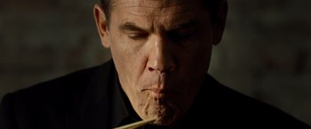 Movie still from “Oldboy” (2013), directed by Spike Lee – A person holding a stick in his mouth; Close Up shot, Low angle