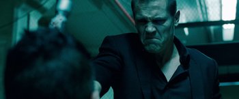 Movie still from “Oldboy” (2013), directed by Spike Lee – A person wearing a suit and tie; Close Up shot, Low angle