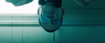 Movie still from “Oldboy” (2013), directed by Spike Lee – A man hanging upside down in a bathroom; Close Up shot, Low angle