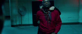Movie still from “Oldboy” (2013), directed by Spike Lee – A man in a red shirt is holding another man; Medium shot, Low angle