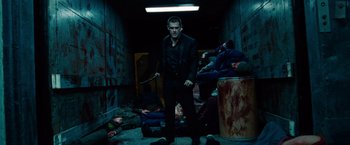 Movie still from “Oldboy” (2013), directed by Spike Lee – A man holding a knife standing in a room with a bunch of corpses on the floor; Wide shot, Low angle
