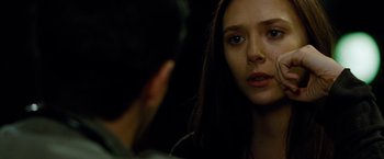 Movie still from “Oldboy” (2013), directed by Spike Lee – A woman looking at a man in the mirror; Close Up shot, Over the shoulder angle