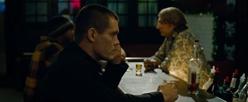 Movie still from “Oldboy” (2013), directed by Spike Lee – A man sitting at a table in front of another man; Close Up shot, Over the shoulder angle