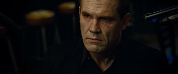 Movie still from “Oldboy” (2013), directed by Spike Lee – A person wearing a black shirt; Close Up shot, Over the shoulder angle