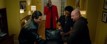 Movie still from “Oldboy” (2013), directed by Spike Lee – A group of men standing next to each other; Medium shot, High angle