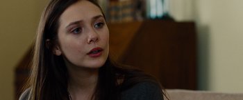 Movie still from “Oldboy” (2013), directed by Spike Lee – A person sitting on a couch; Close Up shot, Over the shoulder angle