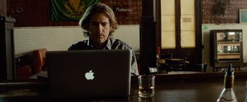 Movie still from “Oldboy” (2013), directed by Spike Lee – A man sitting in front of an open laptop computer; Medium shot, Over the shoulder angle