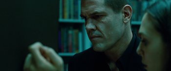 Movie still from “Oldboy” (2013), directed by Spike Lee – A person wearing a suit and tie; Close Up shot, Over the shoulder angle