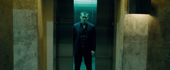 Movie still from “Oldboy” (2013), directed by Spike Lee – A man in a suit standing in an elevator; Medium shot, Low angle