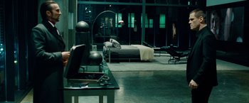 Movie still from “Oldboy” (2013), directed by Spike Lee – A room with a bed , desk , and a large window; Wide shot, High angle
