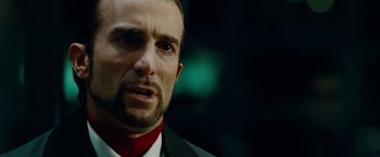 Movie still from “Oldboy” (2013), directed by Spike Lee – A person wearing a suit and tie; Close Up shot, Over the shoulder angle