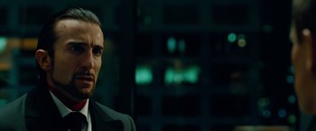 Movie still from “Oldboy” (2013), directed by Spike Lee – A person wearing a suit; Close Up shot, Low angle