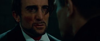 Movie still from “Oldboy” (2013), directed by Spike Lee – A person wearing a suit and tie; Close Up shot, Over the shoulder angle