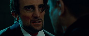 Movie still from “Oldboy” (2013), directed by Spike Lee – A person wearing a suit and tie; Close Up shot, Over the shoulder angle