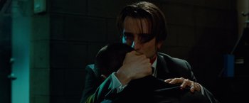 Movie still from “Oldboy” (2013), directed by Spike Lee – A man in a suit and tie hugging another man in a suit and tie; Close Up shot, Over the shoulder angle