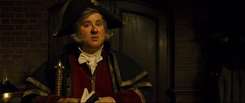 Movie still from “Oliver Twist” (2005), directed by Roman Polanski – A person wearing a costume; Medium shot, Over the shoulder angle