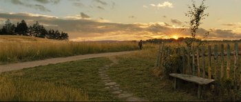Movie still from “Oliver Twist” (2005), directed by Roman Polanski – A dirt road that has some grass on the side of it; Extreme Wide shot, High angle