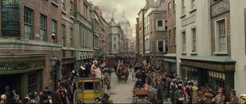 Movie still from “Oliver Twist” (2005), directed by Roman Polanski – An old time picture of a street with a lot of people on it; Extreme Wide shot, High angle
