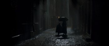 Movie still from “Oliver Twist” (2005), directed by Roman Polanski – Two people under an umbrella in the dark; Extreme Wide shot, High angle