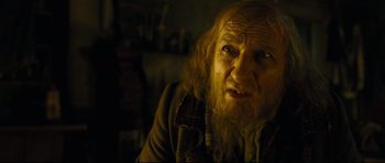 Movie still from “Oliver Twist” (2005), directed by Roman Polanski – An old man with long hair and a long beard; Close Up shot, Over the shoulder angle