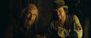 Movie still from “Oliver Twist” (2005), directed by Roman Polanski – A man and a man with a hat and a beard; Close Up shot, Over the shoulder angle
