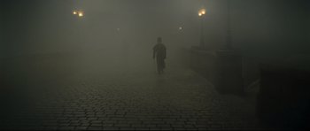 Movie still from “Oliver Twist” (2005), directed by Roman Polanski – A man walking down a street in the fog; Wide shot, High angle