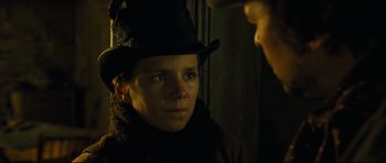 Movie still from “Oliver Twist” (2005), directed by Roman Polanski – A man wearing a black hat and a black scarf; Close Up shot, Over the shoulder angle