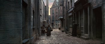 Movie still from “Oliver Twist” (2005), directed by Roman Polanski – An image of a woman in the middle of a city street; Extreme Wide shot, High angle