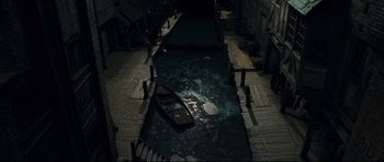 Movie still from “Oliver Twist” (2005), directed by Roman Polanski – An empty boat in the middle of a canal; Extreme Wide shot, Overhead angle