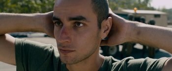 Movie still from “Omar” (2013), directed by Hany Abu-Assad – A person with his head tilted up; Close Up shot, Low angle