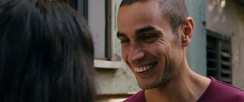 Movie still from “Omar” (2013), directed by Hany Abu-Assad – A person with a smile on their face; Close Up shot, Over the shoulder angle