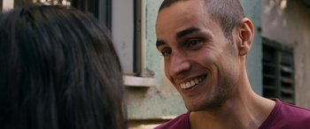 Movie still from “Omar” (2013), directed by Hany Abu-Assad – A person with a smile on their face; Close Up shot, Over the shoulder angle
