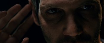 Movie still from “Omar” (2013), directed by Hany Abu-Assad – A man's face with dark lighting; Extreme Close Up shot, Low angle