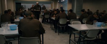 Movie still from “Omar” (2013), directed by Hany Abu-Assad – A group of people sitting at tables in a room; Wide shot, High angle