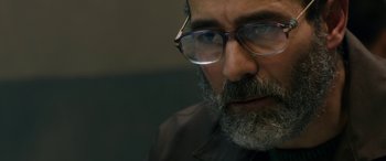 Movie still from “Omar” (2013), directed by Hany Abu-Assad – A person wearing glasses; Close Up shot, Over the shoulder angle