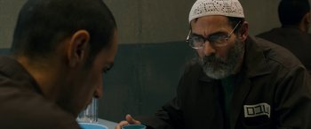Movie still from “Omar” (2013), directed by Hany Abu-Assad – An older man and a younger man are having a conversation; Close Up shot, Over the shoulder angle