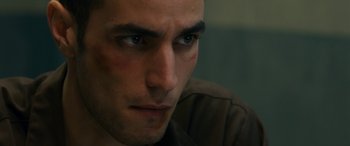 Movie still from “Omar” (2013), directed by Hany Abu-Assad – A man's face in a dark room; Close Up shot, Low angle