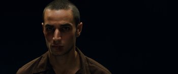 Movie still from “Omar” (2013), directed by Hany Abu-Assad – A person wearing a brown shirt; Close Up shot, Low angle