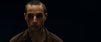 Movie still from “Omar” (2013), directed by Hany Abu-Assad – A person wearing a brown shirt; Close Up shot, Low angle