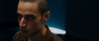 Movie still from “Omar” (2013), directed by Hany Abu-Assad – A person's face in a dark room; Close Up shot, Low angle