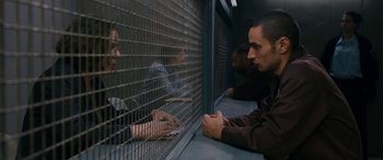Movie still from “Omar” (2013), directed by Hany Abu-Assad – A group of people sitting in a room next to each other; Medium shot, Over the shoulder angle