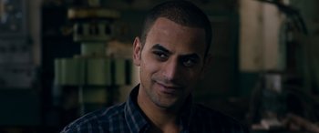 Movie still from “Omar” (2013), directed by Hany Abu-Assad – A person wearing a plaid shirt; Close Up shot, Low angle